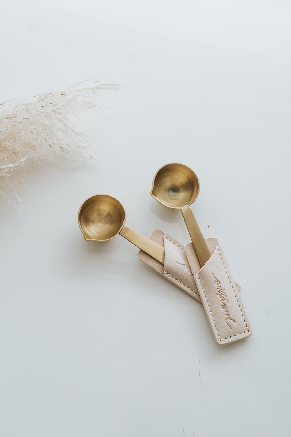 Brass wax seal melting spoons with pouring spouts in beige leather sleeve
