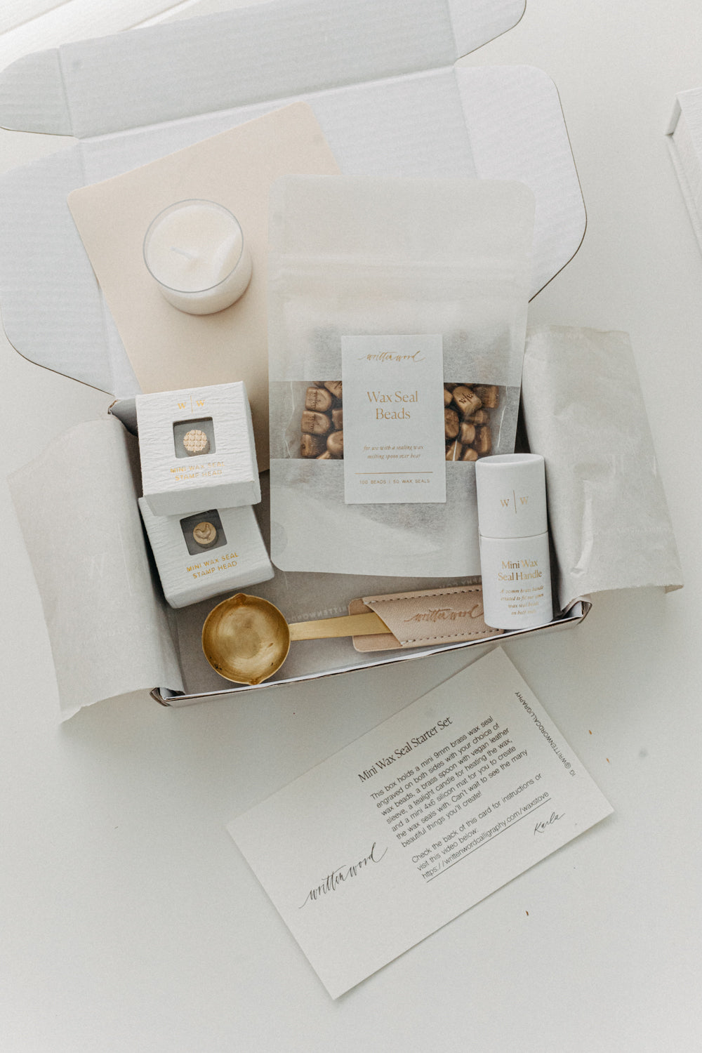 Mini wax seal starter kit with stamp heads, wax beads, brass spoon and candle
