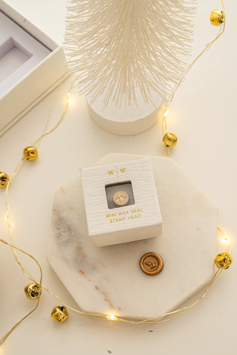 Boxed mini wax seal stamp with ice skates design and gold wax impression, part of Written Word Calligraphy’s Holiday Collection.