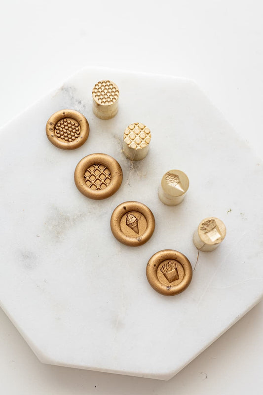 Food-themed mini wax seal stamps with bubble waffle, Belgian waffle, ice cream, and fries designs, shown with matching gold wax seal impressions.