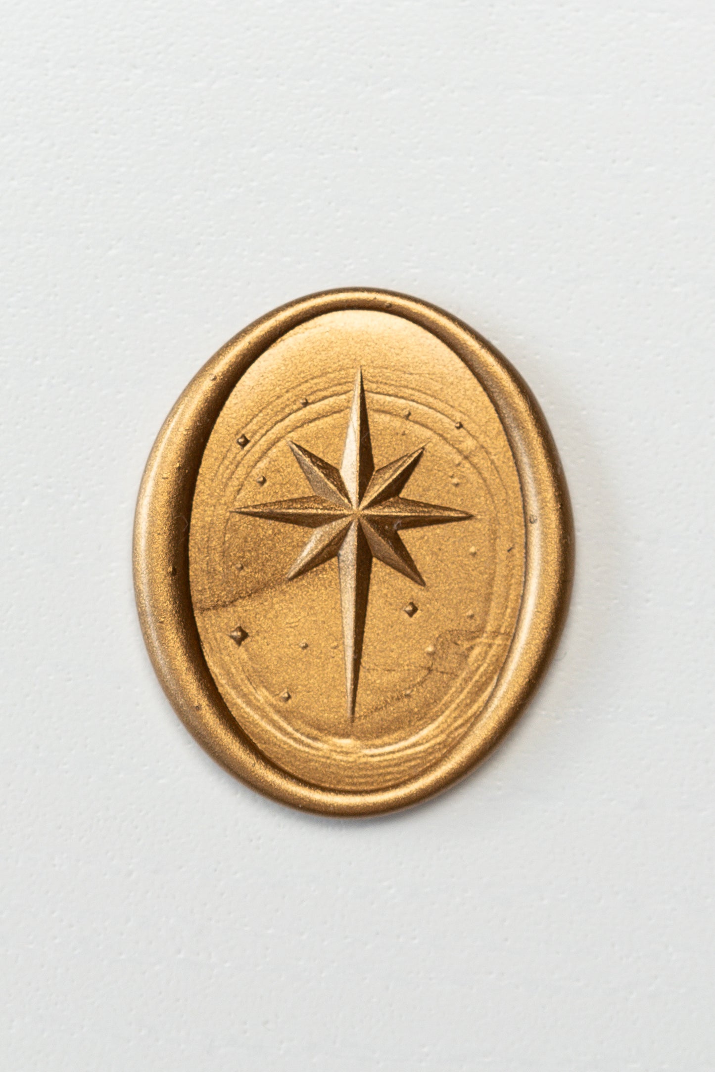 Gold wax seal with Star of Bethlehem design on neutral background, embossed wax seal for envelopes and stationery