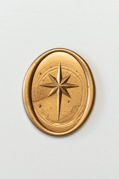 Gold wax seal with Star of Bethlehem design on neutral background, embossed wax seal for envelopes and stationery