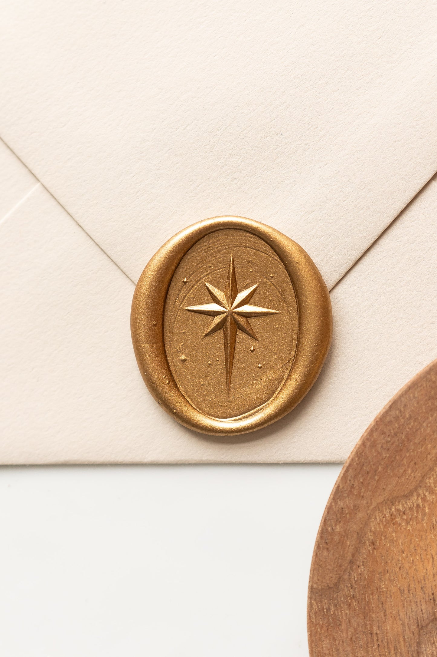 Close up gold star of Bethlehem wax seal on cream envelope, festive wax seal for Christmas cards and invitations