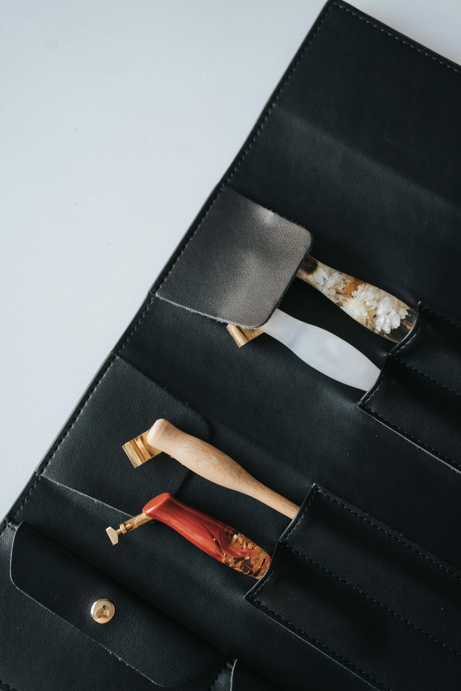 Detail of black pen roll case with oblique calligraphy pens and soft interior lining