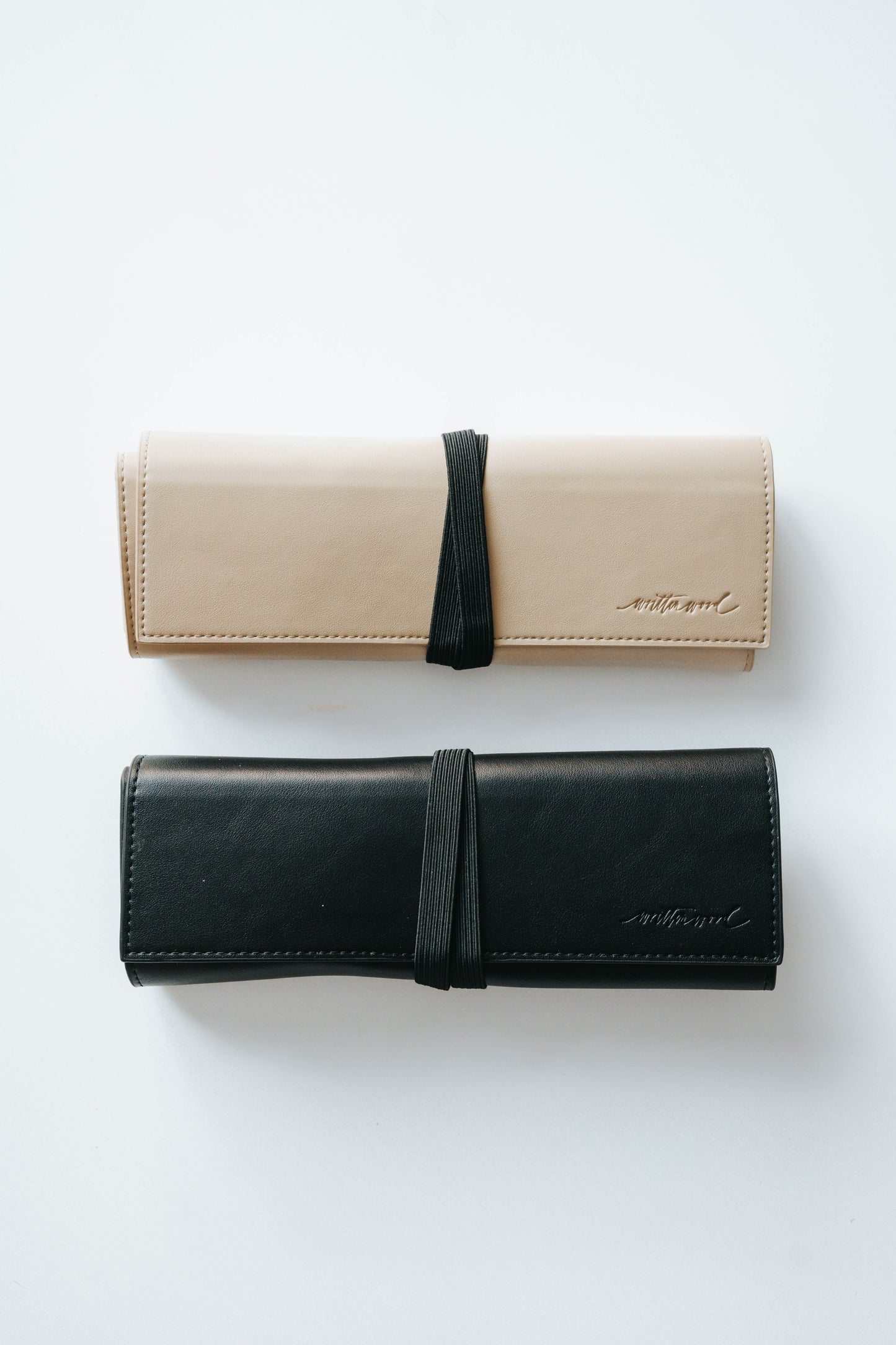 Beige and black calligraphy pen roll cases with elastic closure for storing oblique or straight penholders