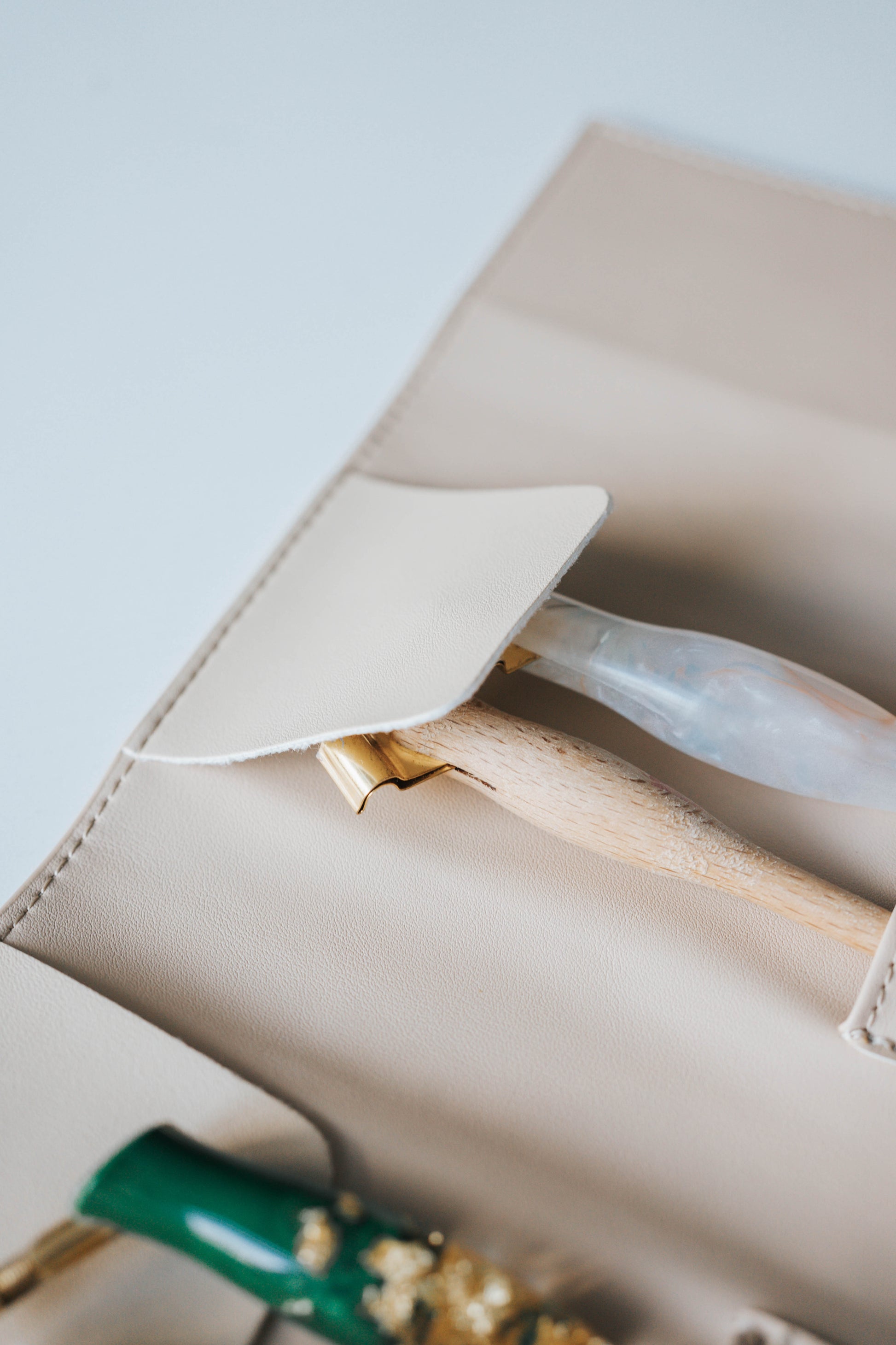 Close-up of beige pen roll interior showing penholder slot and flap closure detail