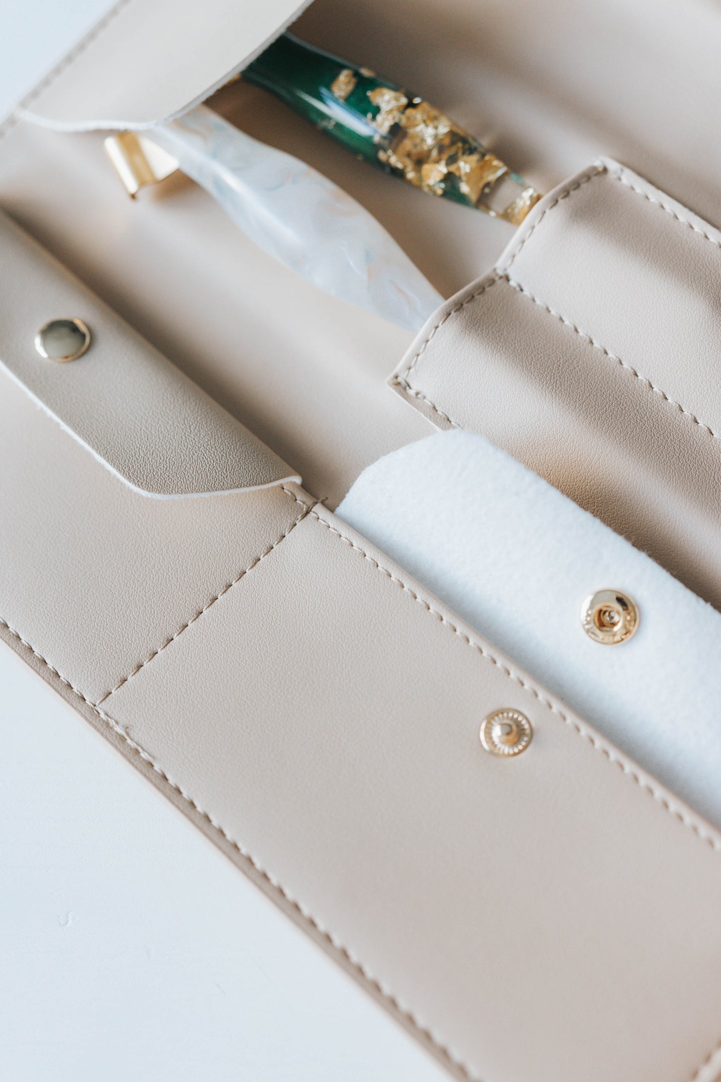 Beige calligraphy pen roll with oblique penholders stored in stitched compartments