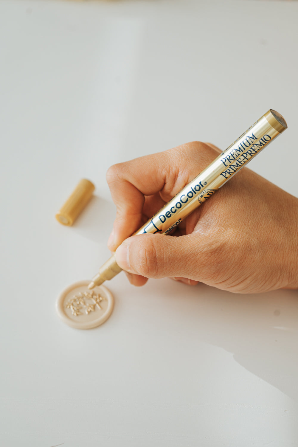 Marvy Uchida DecoColor Premium Fine Point gold paint pen with a beige wax seal