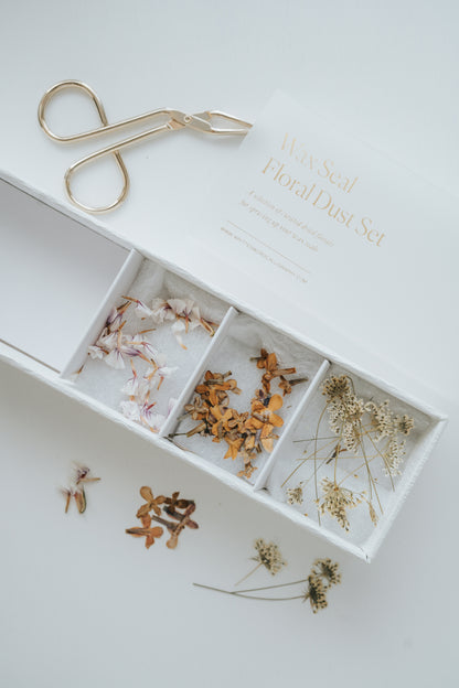 Wax Seal Floral Dust Set with dried flowers in a white box, perfect for decorating wax seals. Gold tweezers included.