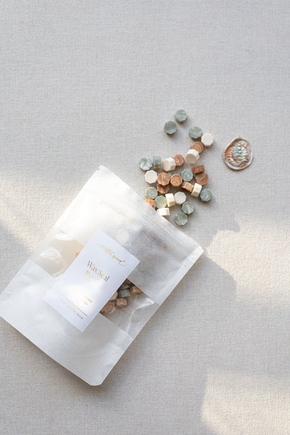 Cozy Pine wax seal beads in sage green, ivory, and copper tones with packaging and finished wax seal example