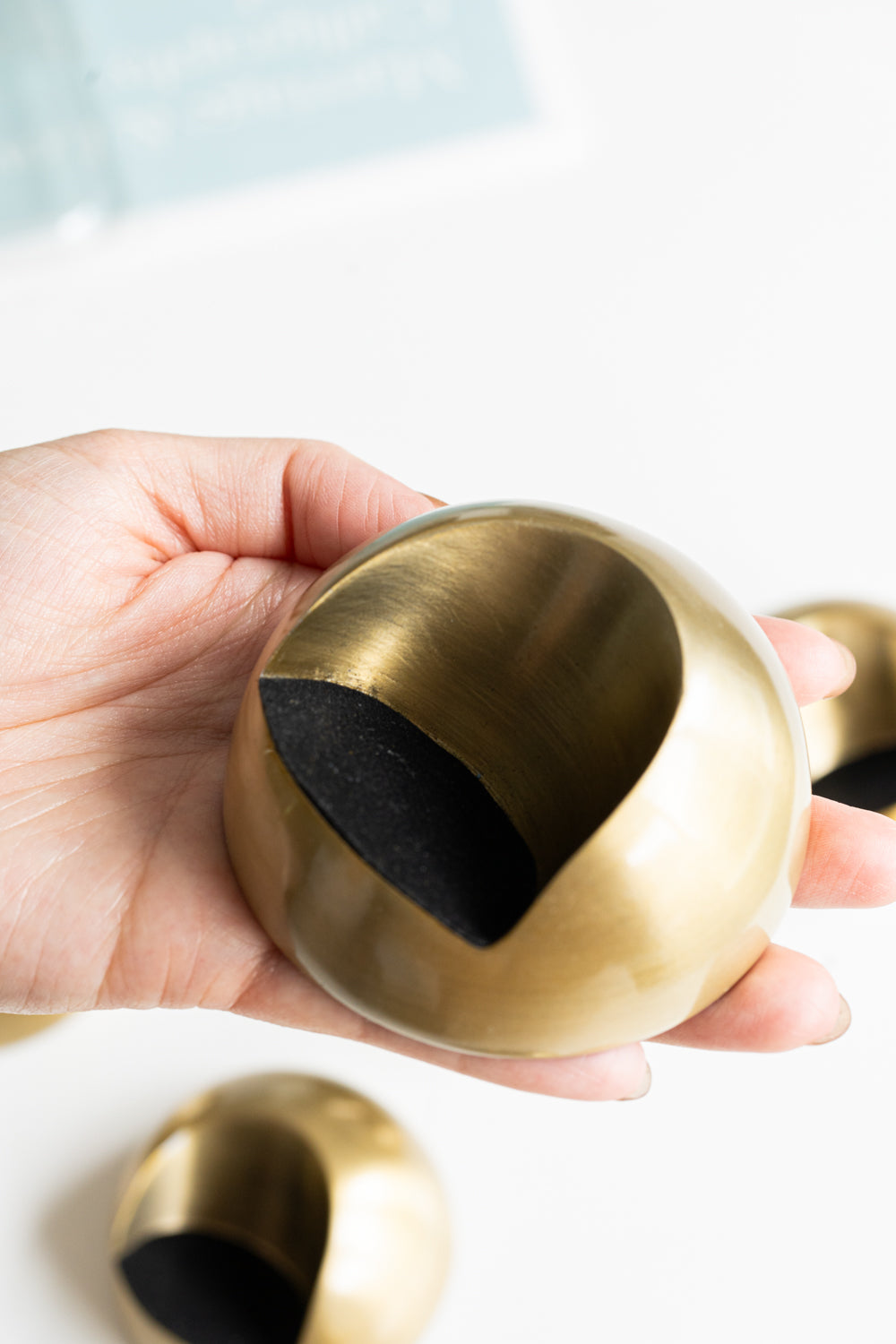 Elegant brass inkwell with a smooth cutout design and black interior, ideal for stylish desk organization and ink storage
