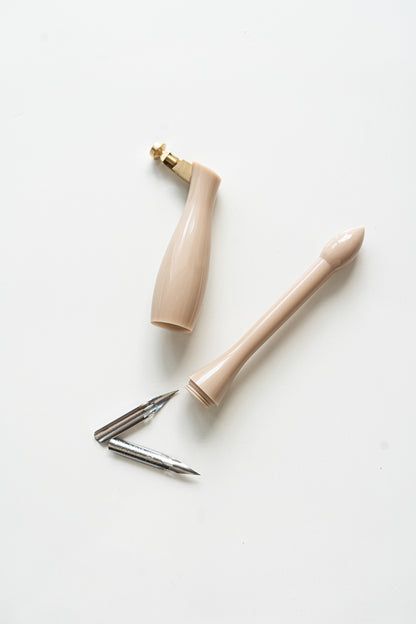 Beige universal calligraphy pen holder with nibs, modern calligraphy supplies flat lay