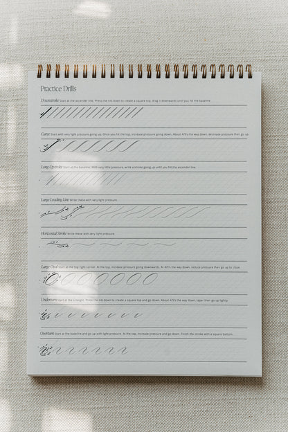 Calligraphy practice pad with drills for downstrokes, curves, and various strokes for beginners