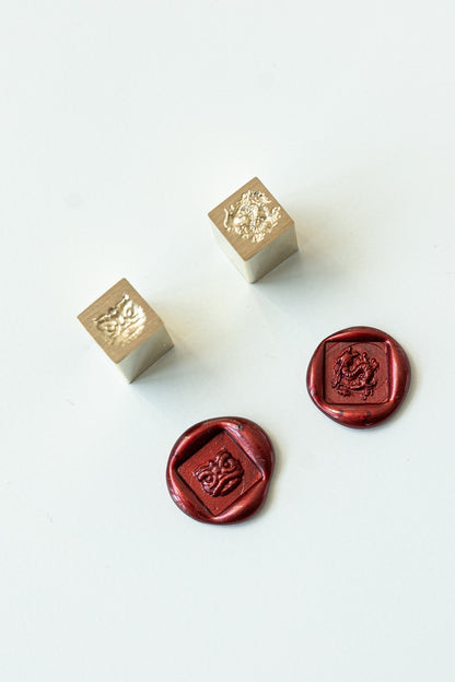 Two square mini wax seal with a lion dance head or dragon engraved with two red wax seals showcasing the designs