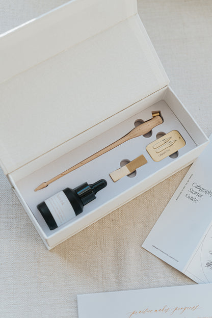 Elegant Mini Calligraphy Starter Kit with wooden pen holder, sumi ink, nibs, and guide, perfect for beginners in script writing.