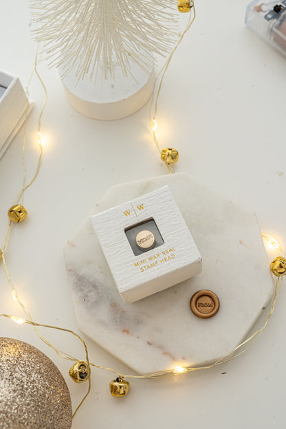 Boxed mini wax seal stamp with “FROM” design and gold wax impression, part of Written Word Calligraphy’s Holiday Collection.