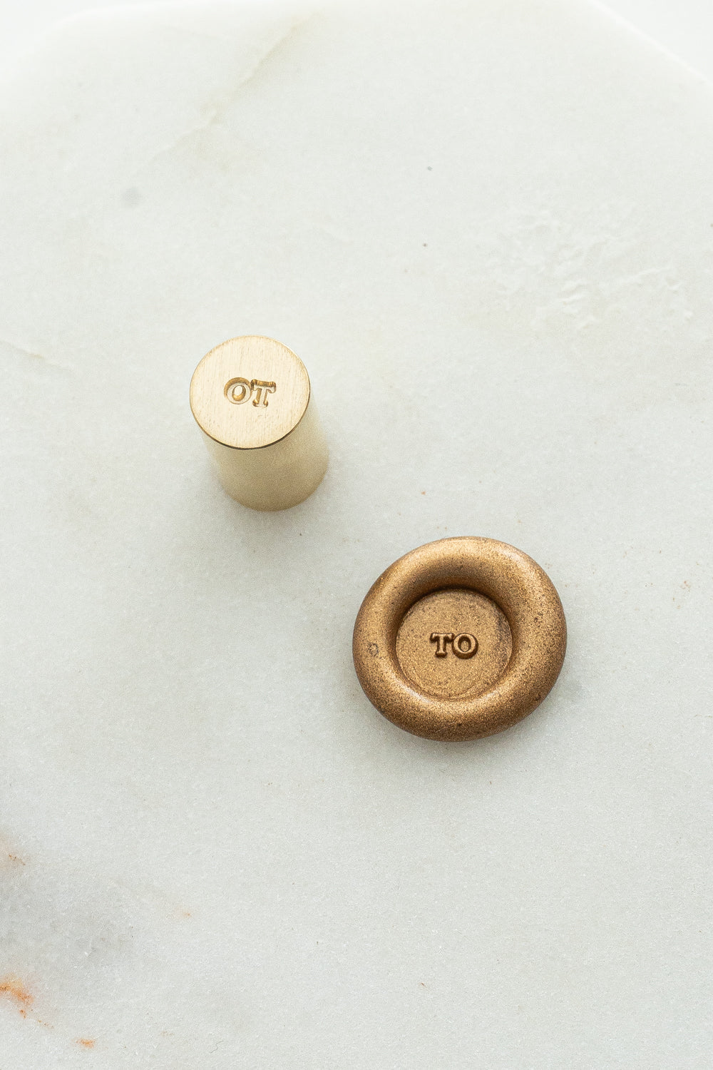 Close-up of mini wax seal stamp with “TO” design in gold wax, part of Written Word Calligraphy’s Holiday Collection.