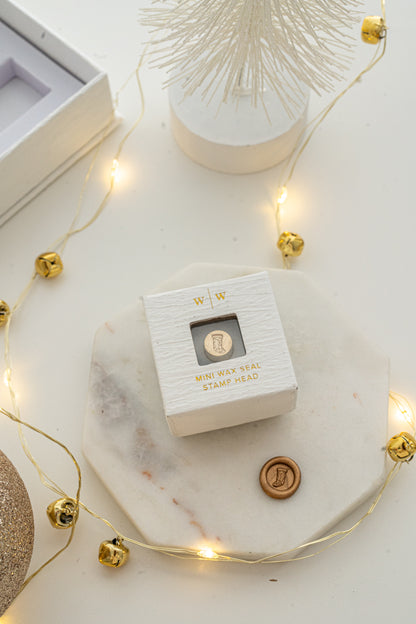 Boxed mini wax seal stamp with Christmas stocking design and gold wax impression, part of Written Word Calligraphy’s Holiday Collection.