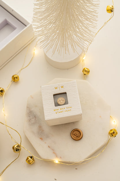 Boxed mini wax seal stamp with ice skates design and gold wax impression, part of Written Word Calligraphy’s Holiday Collection.