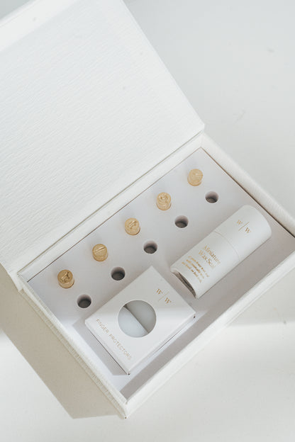 5 mini brass wax seal stamp heads featuring a cow, pig, carrot, chicken, and fish designs, neatly arranged in a keepsake white box with finger protectors and stamp handle