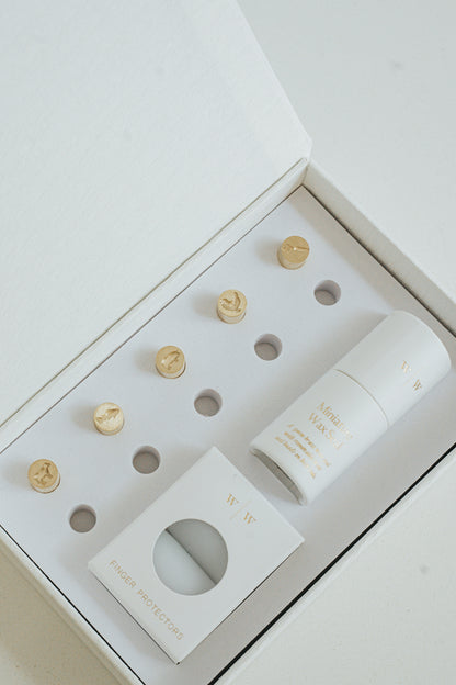 5 mini brass wax seal stamp heads featuring a cow, pig, carrot, chicken, and fish designs, neatly arranged in a keepsake white box with finger protectors and stamp handle