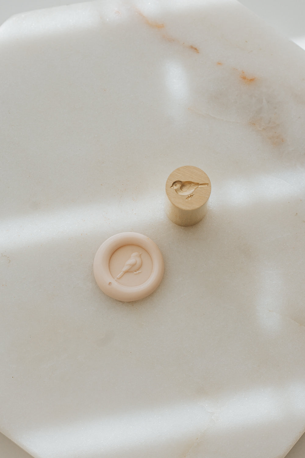 Mini songbird wax seal stamp with sakura wax seal on marble background