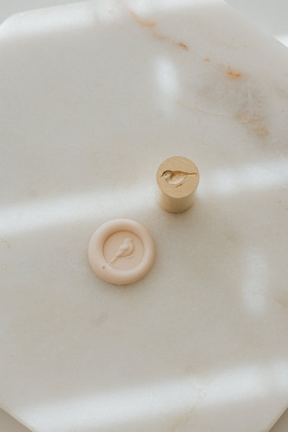 Mini songbird wax seal stamp with sakura wax seal on marble background