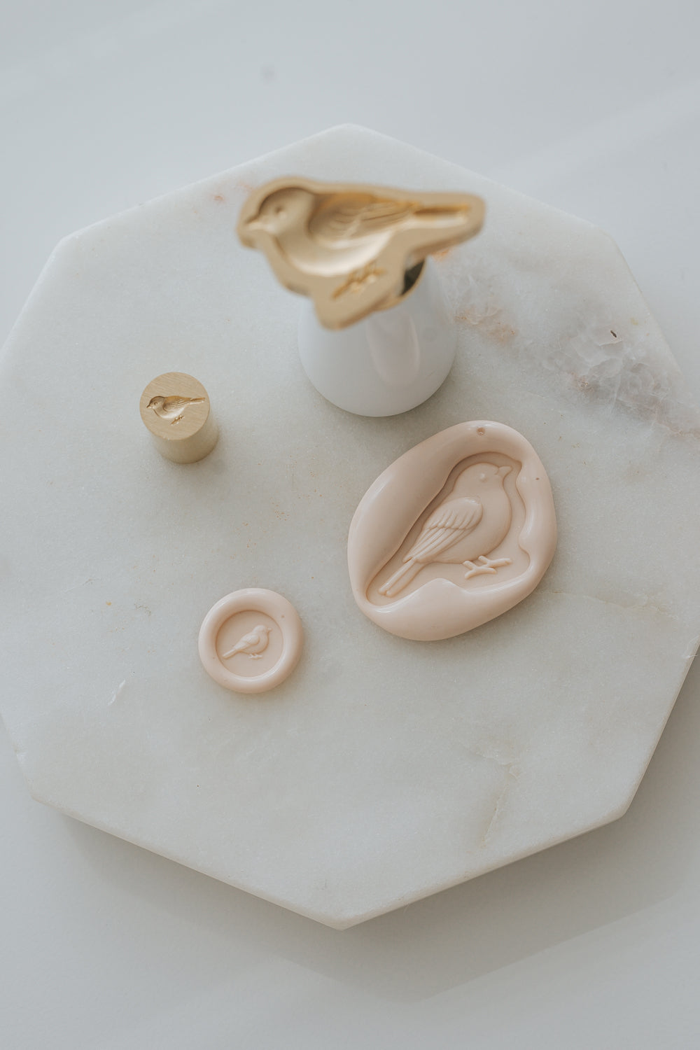 Songbird wax seal stamp with sakura wax seal impressions on marble