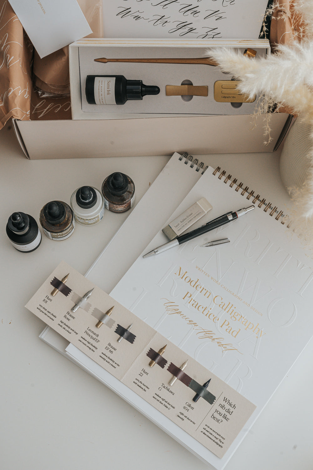 Calligraphy supplies set with ink bottles, nib sampler, pen holder, and practice pad