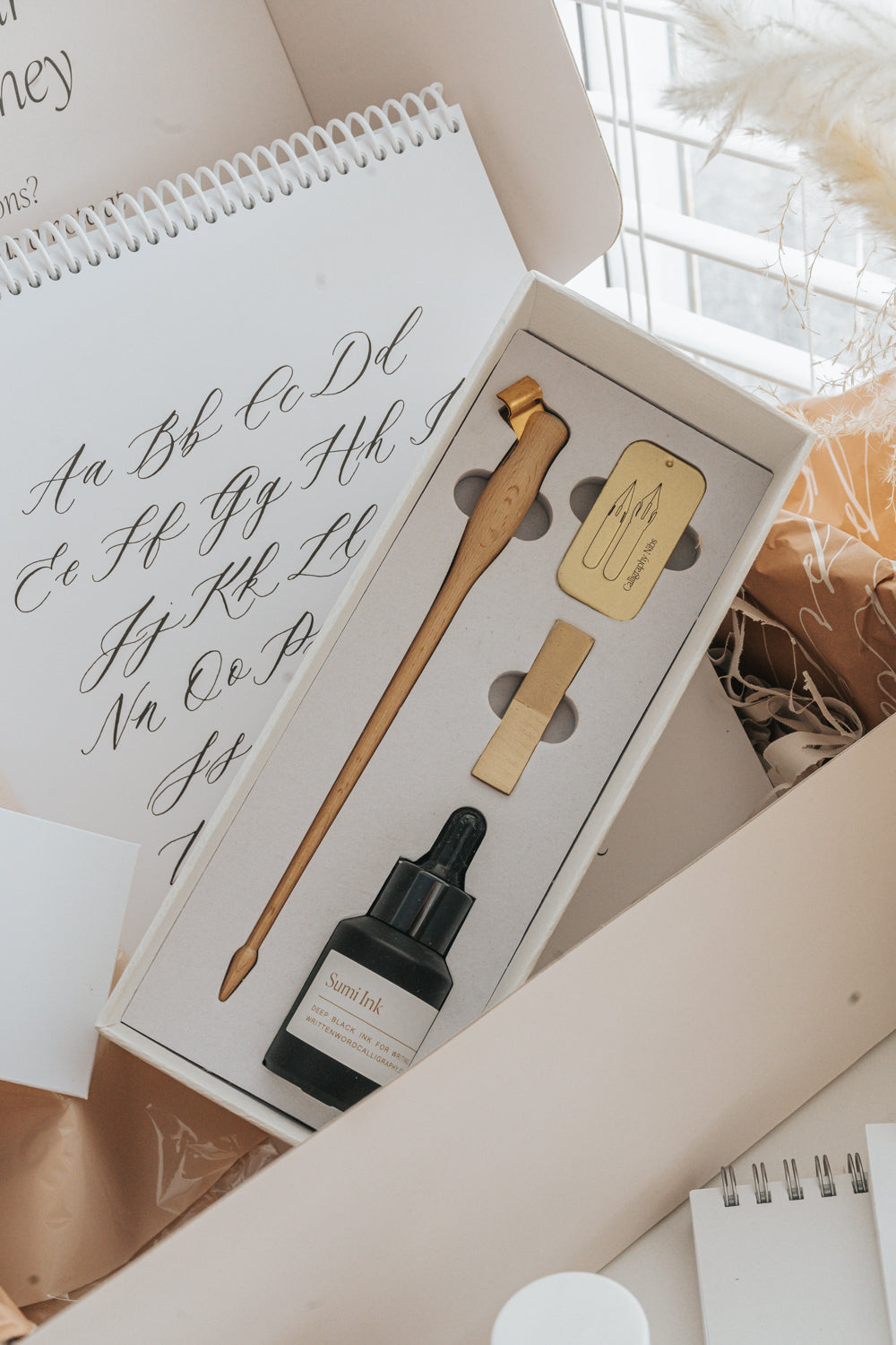 Modern calligraphy starter kit with pen holder, sumi ink, nibs, and practice sheets in gift box
