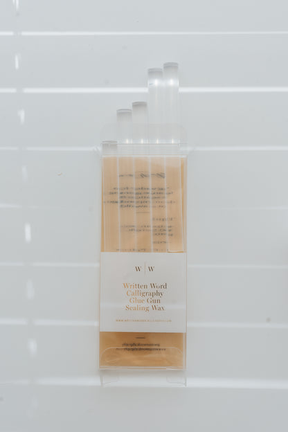 Clear sealing wax sticks in packaging with soft window light shadows