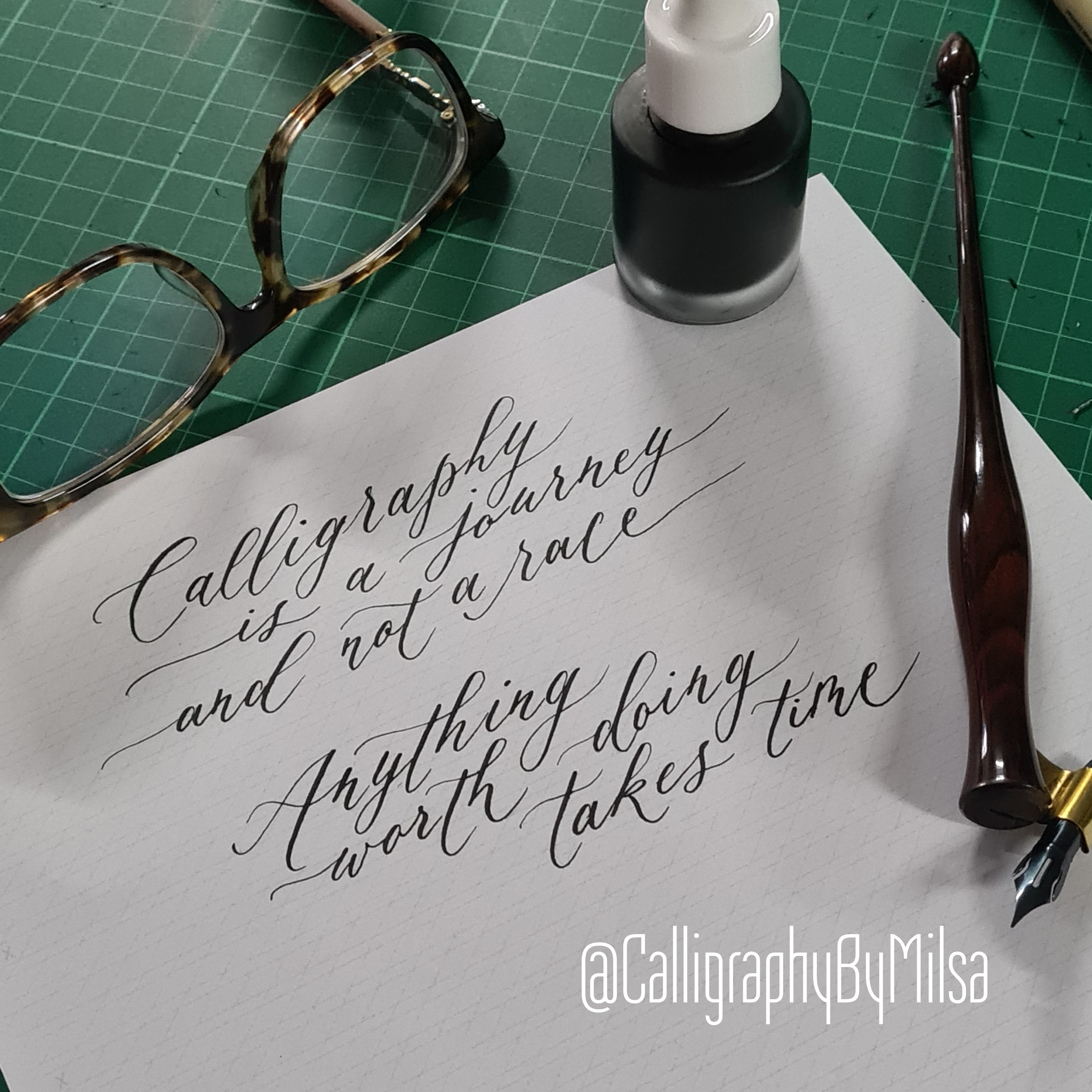 Modern calligraphy practice quote written with pointed pen, sumi ink, and oblique pen holder on calligraphy guideline paper.
