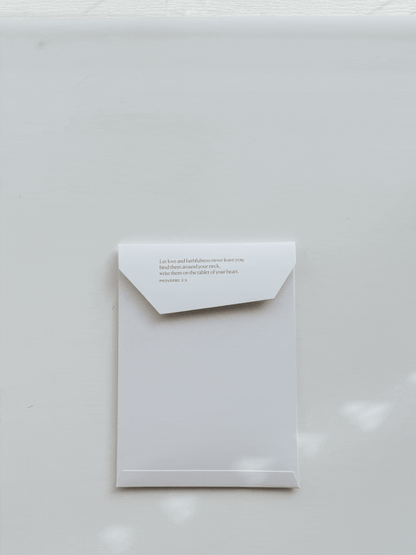 Envelope with printed Bible verse from Proverbs 3:3, minimal Christian snail mail packaging