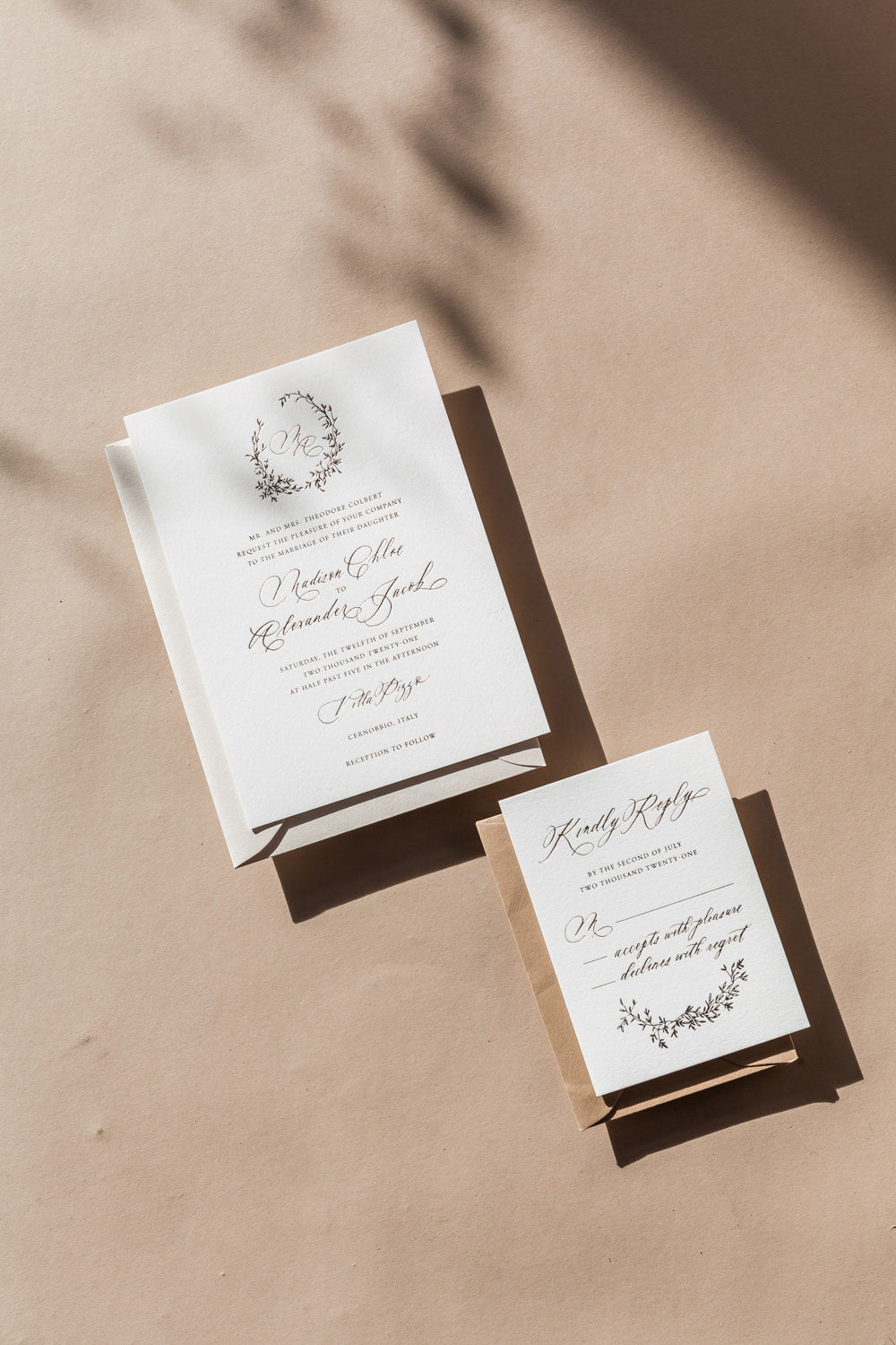 Minimal wedding invitation suite with RSVP card, modern calligraphy and monogram wreath on neutral background