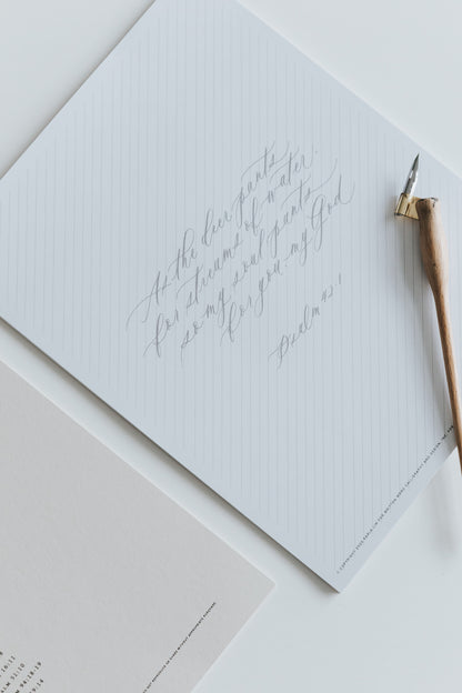 Modern calligraphy practice sheet featuring Psalm verse with slanted guide lines
