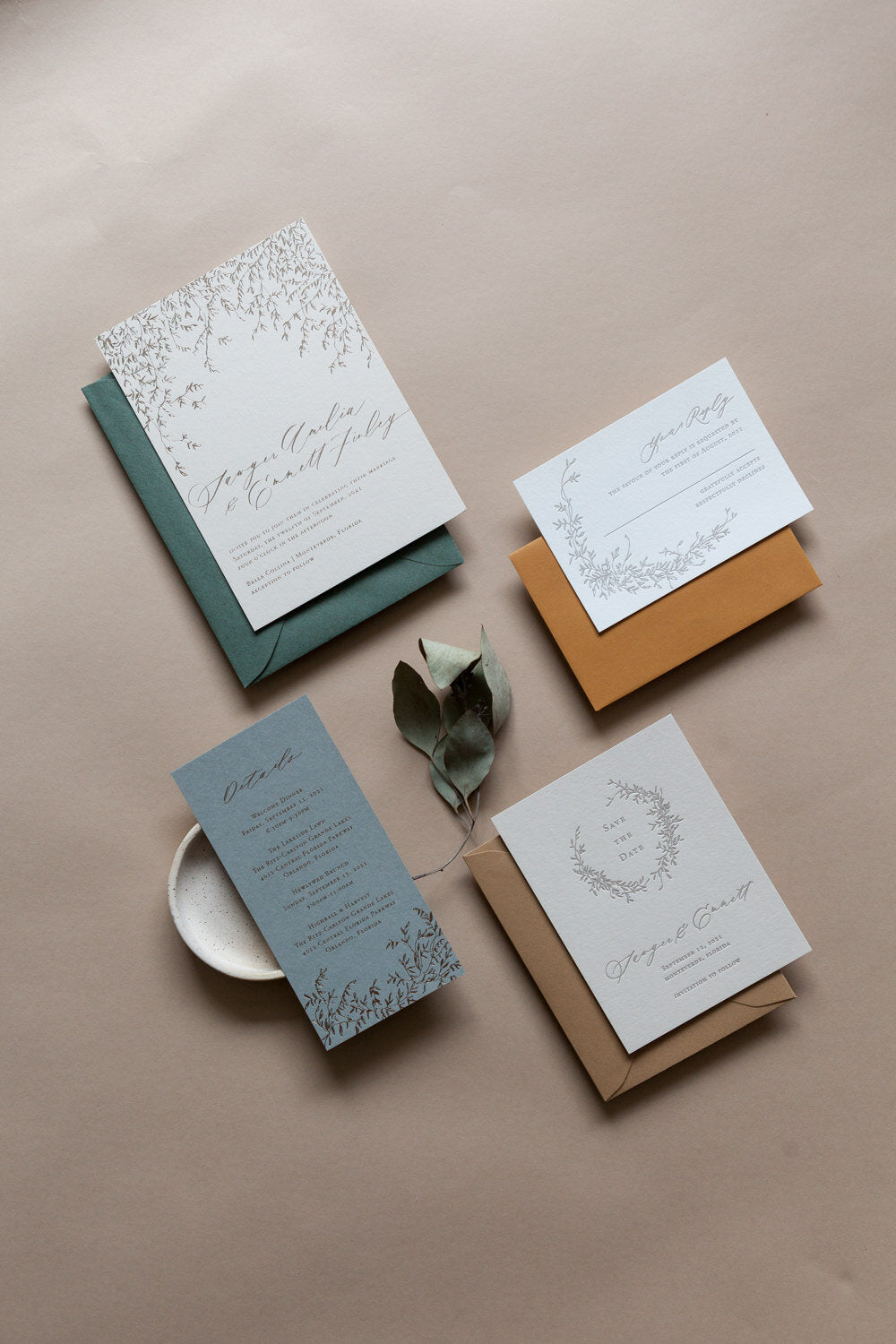 Wedding invitation suite with RSVP, details, and save the date cards in botanical design and neutral tones