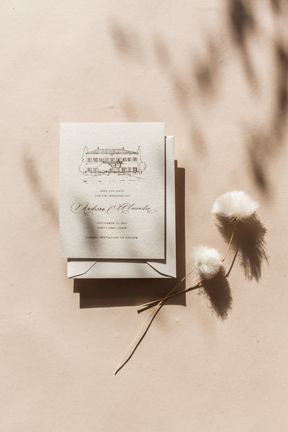 Minimalist save the date card with hand drawn venue illustration and modern calligraphy on neutral wedding stationery