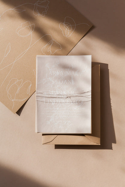 Minimalist wedding invitation with vellum overlay, soft floral line art and modern calligraphy on neutral stationery
