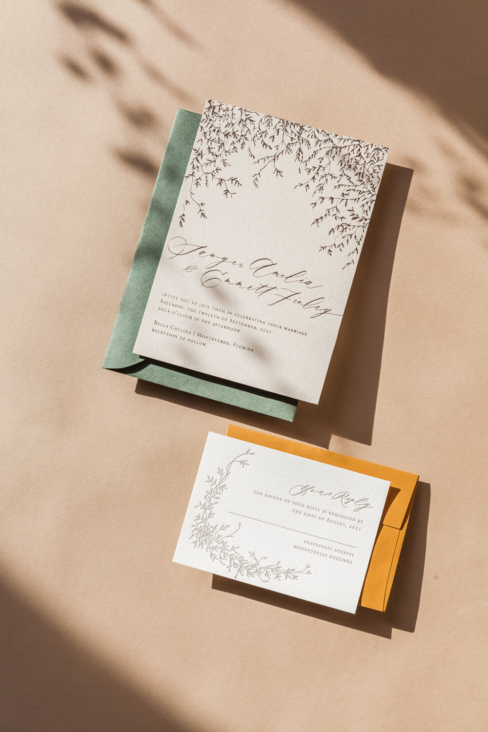 Elegant wedding invitation and RSVP cards with cascading vine illustration and soft neutral styling