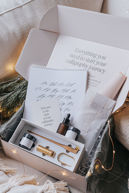 Calligraphy starter kit with tools, inks, practice pad, and instruction card for beginners to start their calligraphy journey