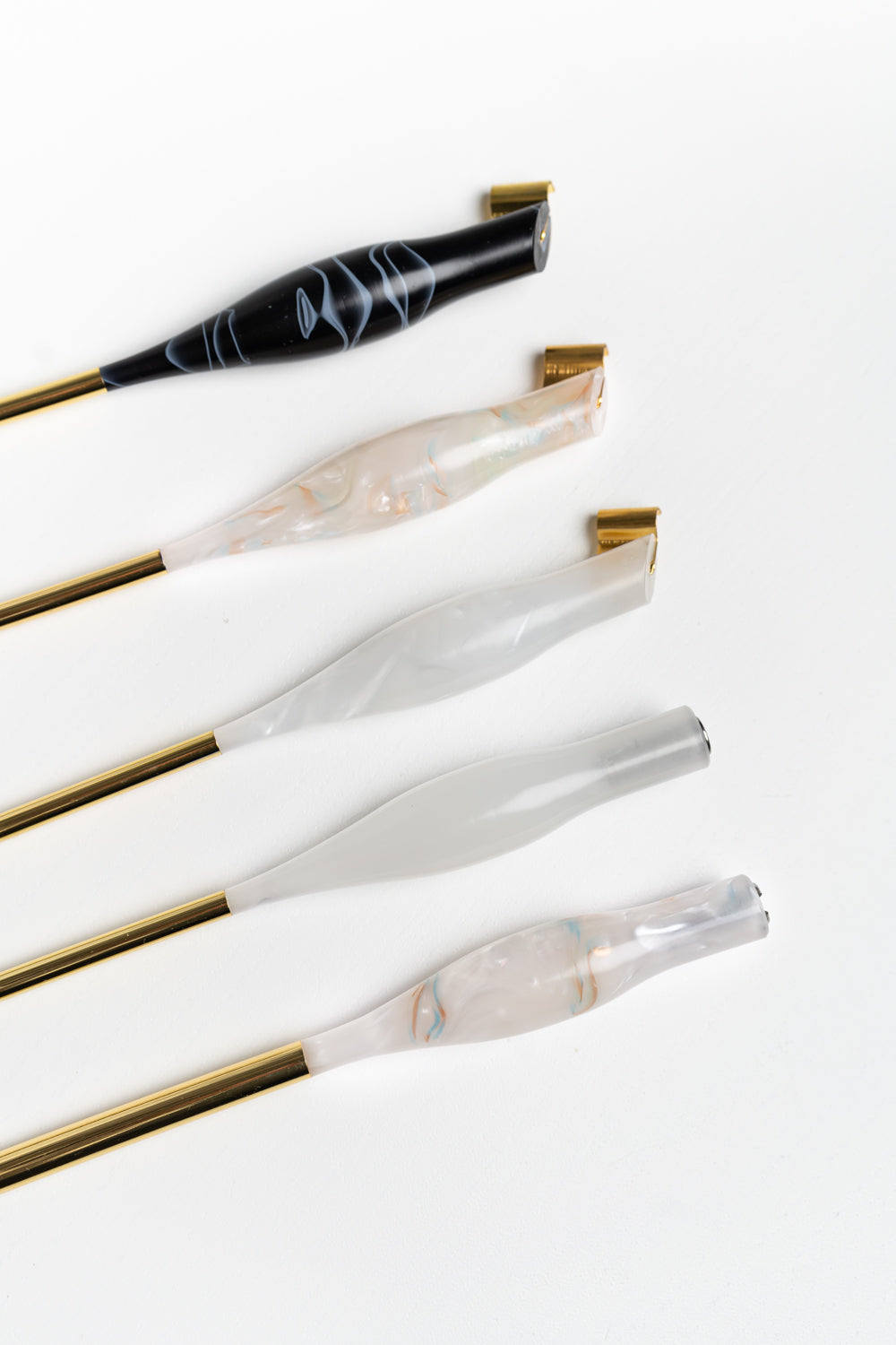 Five handmade calligraphy pens with gold tails in black, white, and rose quartz, suitable for both left and right-handed users