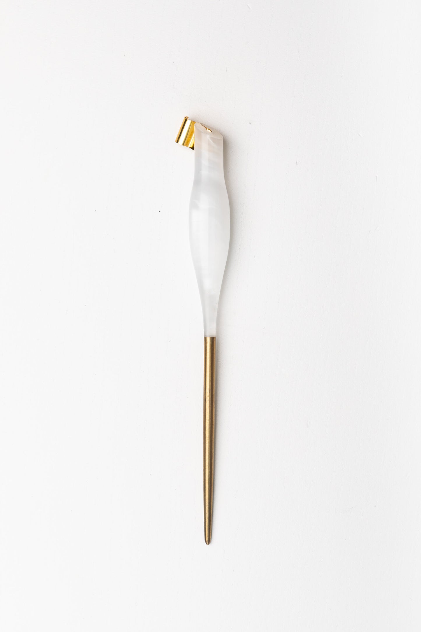 Handmade oblique calligraphy pen with a pearl-white resin body, ergonomic grip, brass tip, and modern asymmetric slant