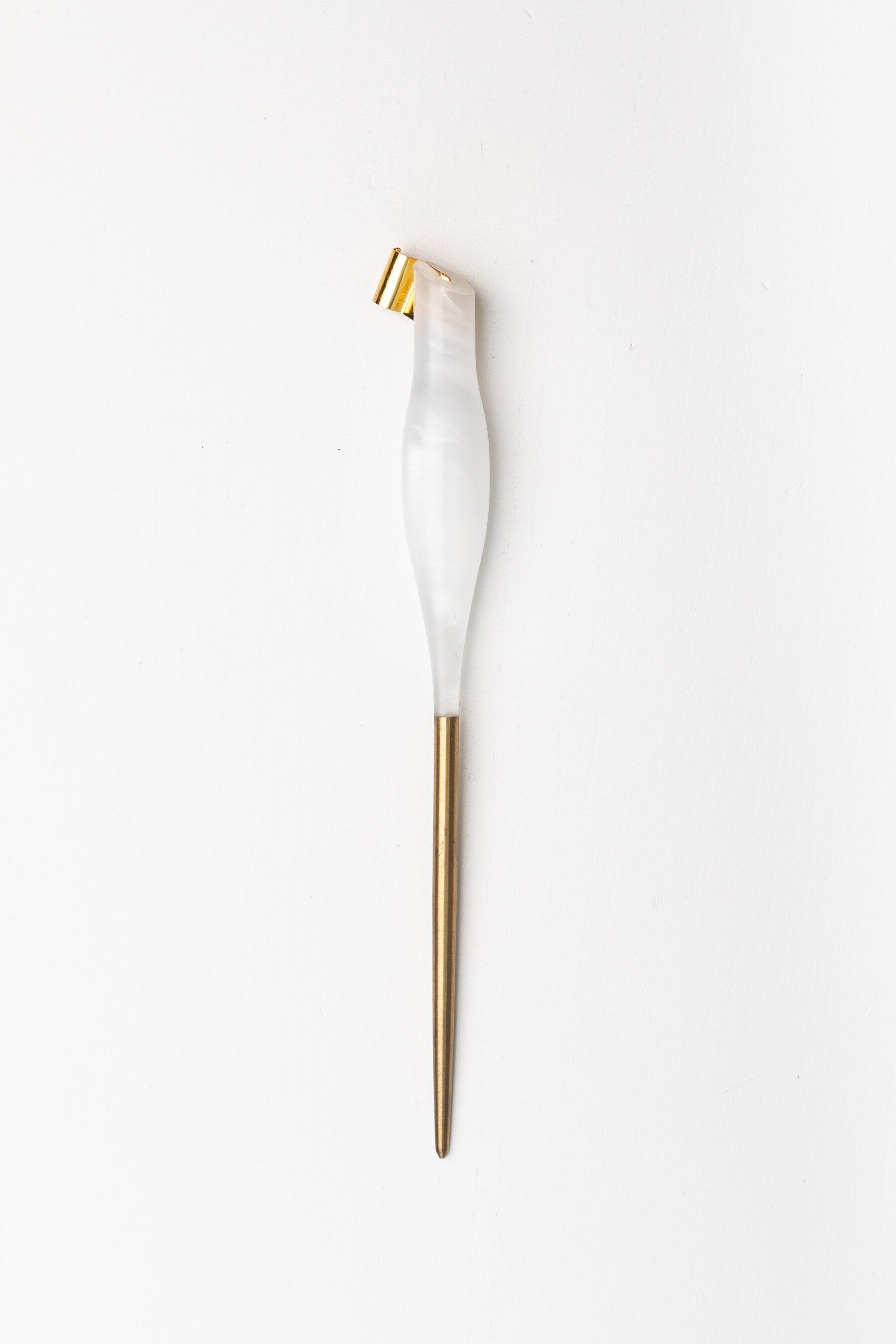 Handmade oblique calligraphy pen with a pearl-white resin body, ergonomic grip, brass tip, and modern asymmetric slant