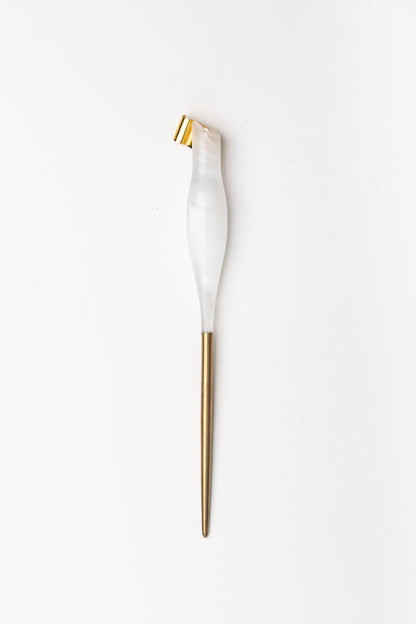 Handmade oblique calligraphy pen with a pearl-white resin body, ergonomic grip, brass tip, and modern asymmetric slant