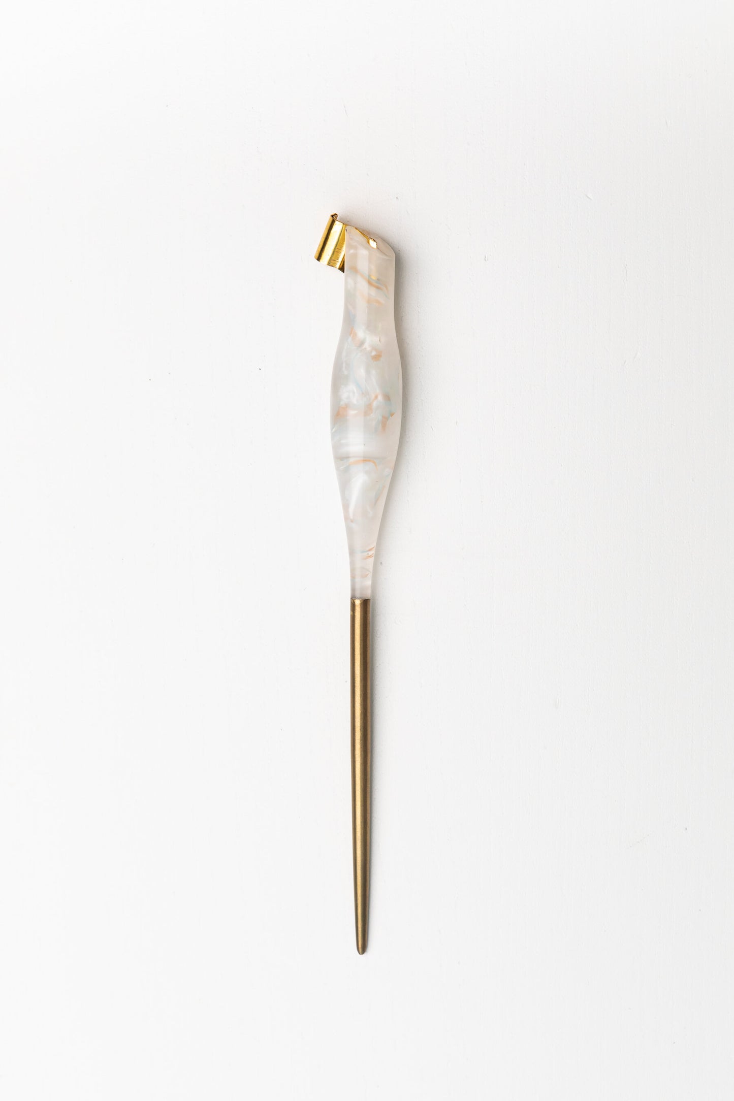 Handmade oblique calligraphy pen with a marbled resin body, ergonomic grip, brass tip, and modern asymmetric slant