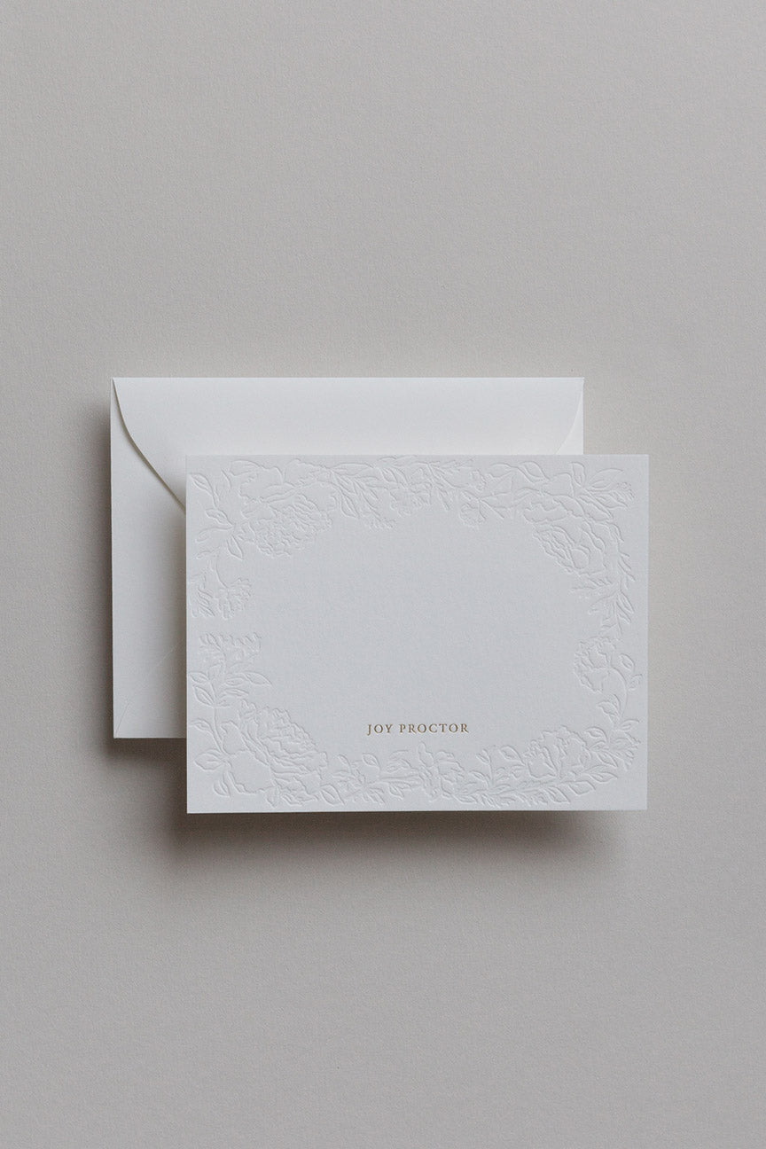 Personalized embossed stationery card with envelope in soft neutral setting