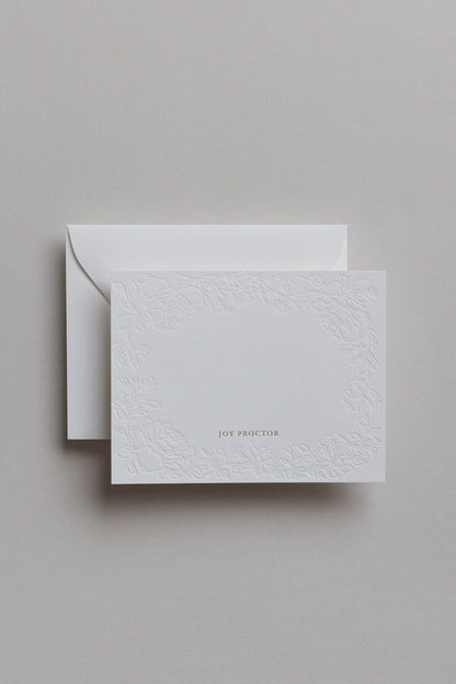 Personalized embossed stationery card with envelope in soft neutral setting
