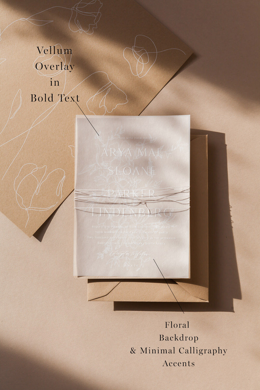 Vellum overlay wedding invitation with minimalist calligraphy, floral backdrop and neutral modern stationery suite