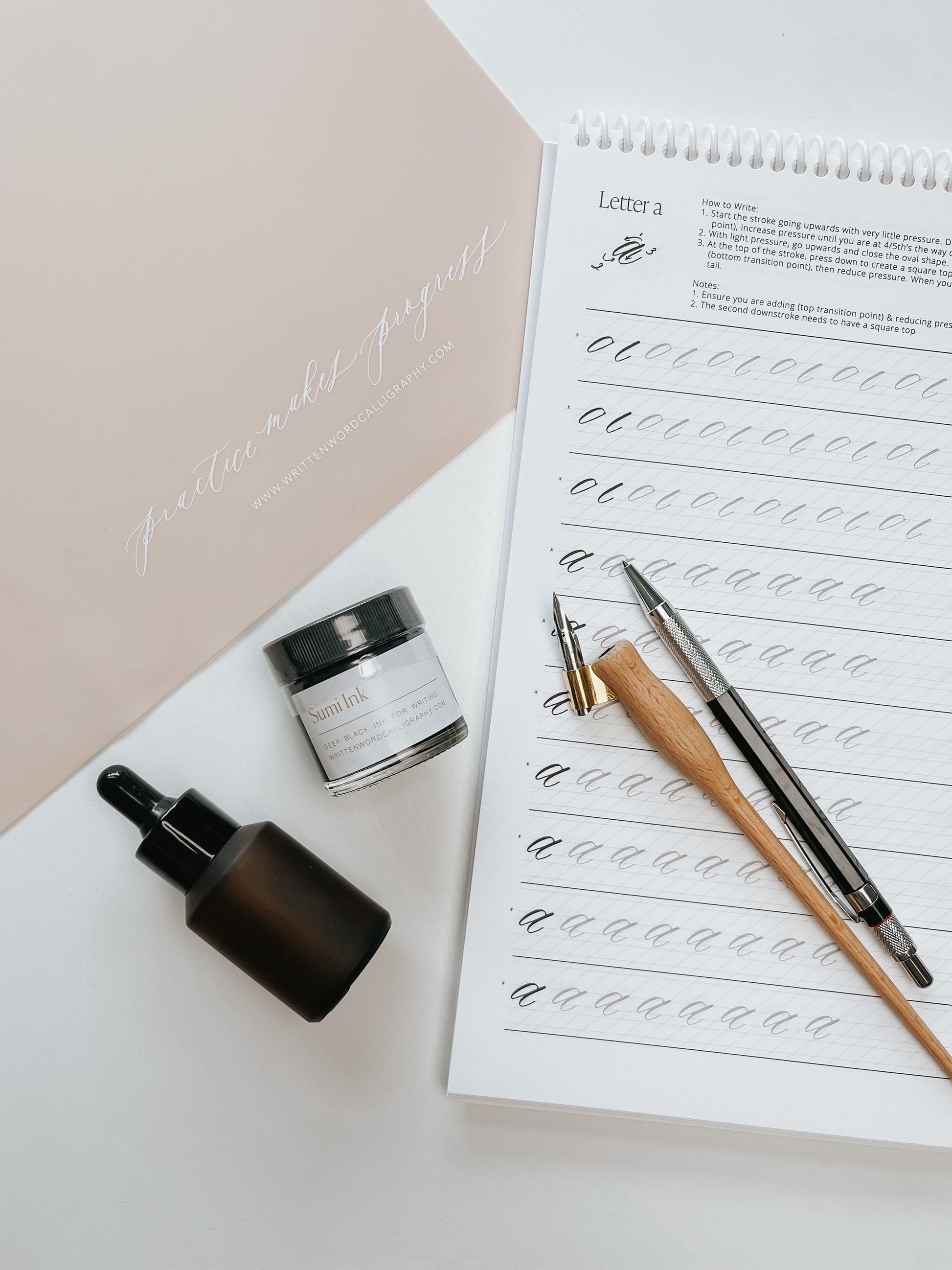 Sumi ink, dip pen holders, nibs, and calligraphy guide for practicing modern calligraphy strokes