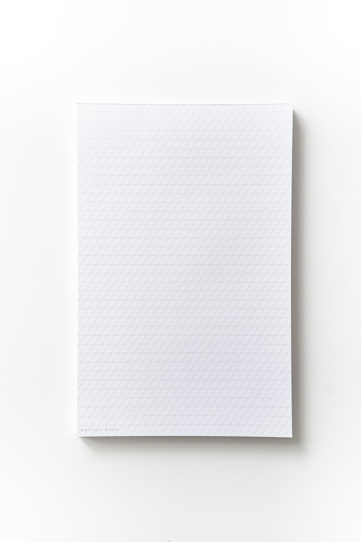 Slanted guide notepad with a 55-degree slant, featuring 50 ink-friendly sheets for calligraphy practice
